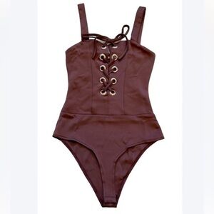 CHARLOTTE RUSSE burgundy one piece lace up bodysuit. New condition. Bottom snaps